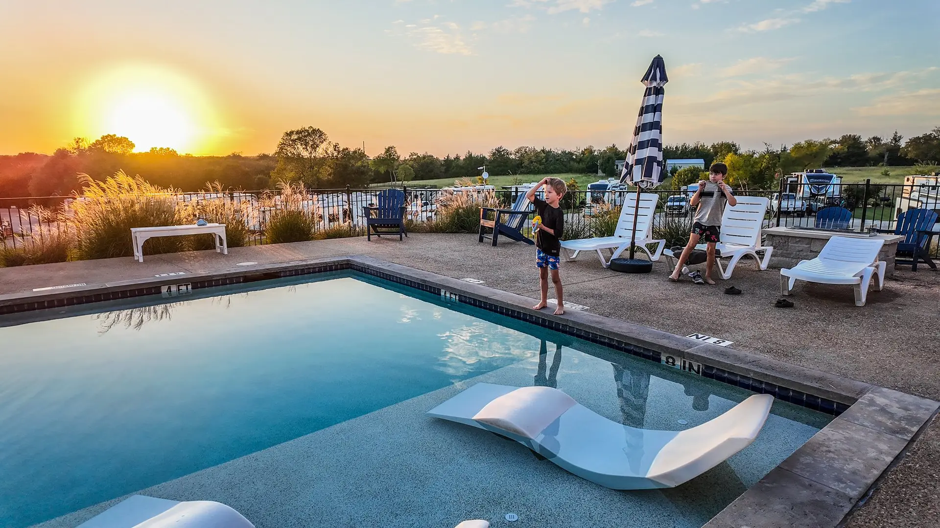 Resort pool sun shelf and loungers in warm light — a lively, welcoming setting for gatherings and Sweet Life events at Sugar Hill.